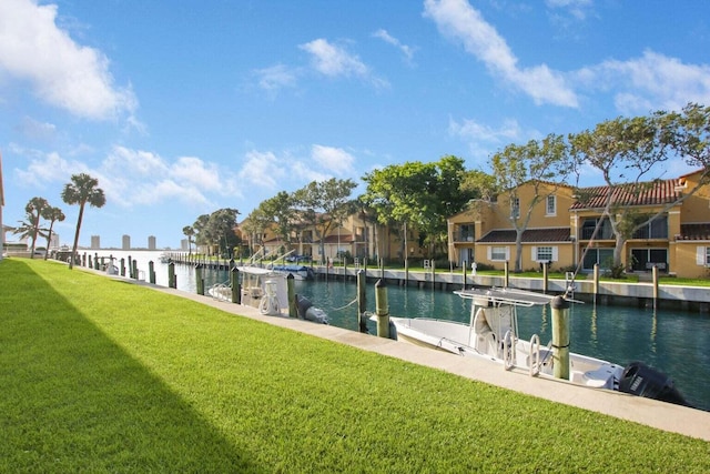 exterior space with a boat dock, a water view, a residential view, and a yard