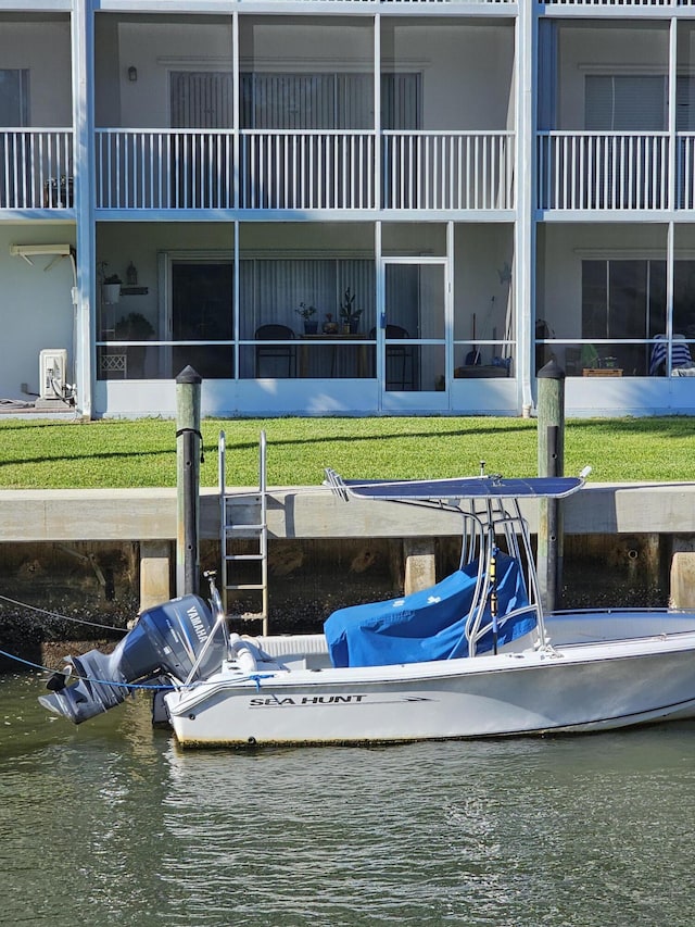 dock area featuring a lawn and a water view