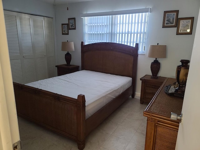 bedroom featuring light tile patterned floors and a closet