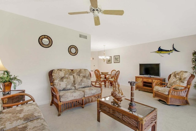 living area featuring ceiling fan with notable chandelier and visible vents