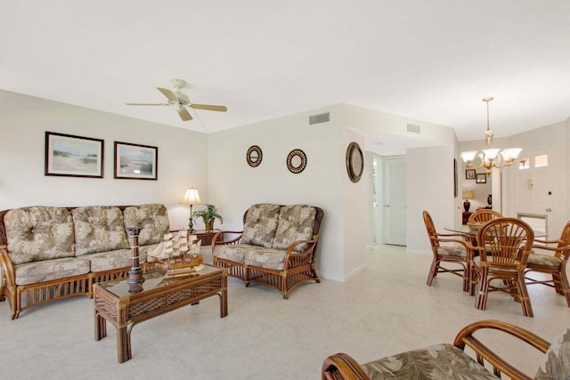 living area featuring visible vents and ceiling fan with notable chandelier