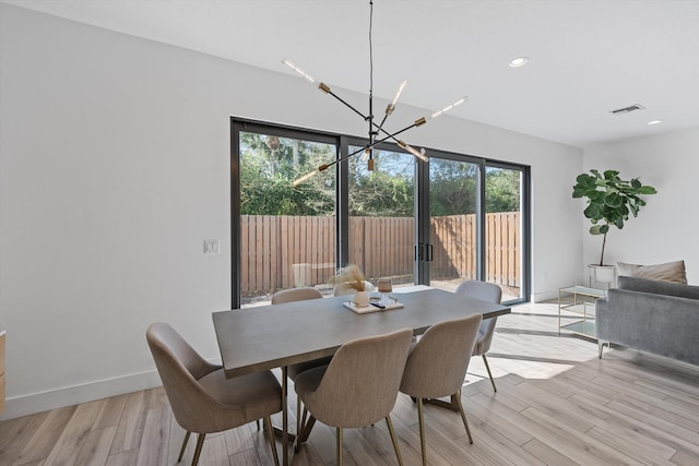 dining space with visible vents, baseboards, an inviting chandelier, light wood-style floors, and recessed lighting