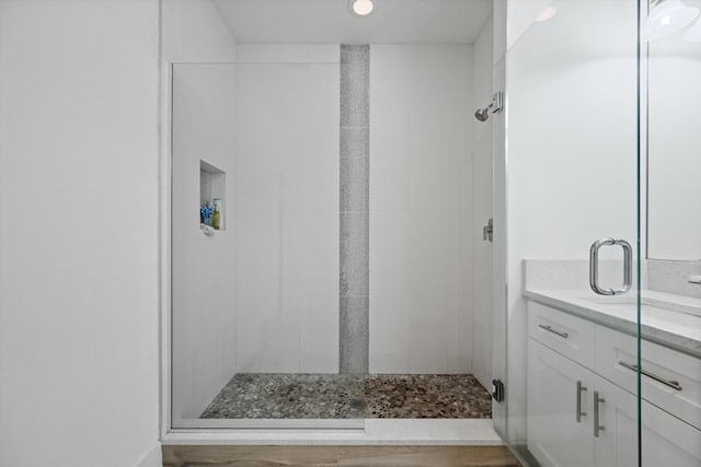 full bath with a shower stall and vanity