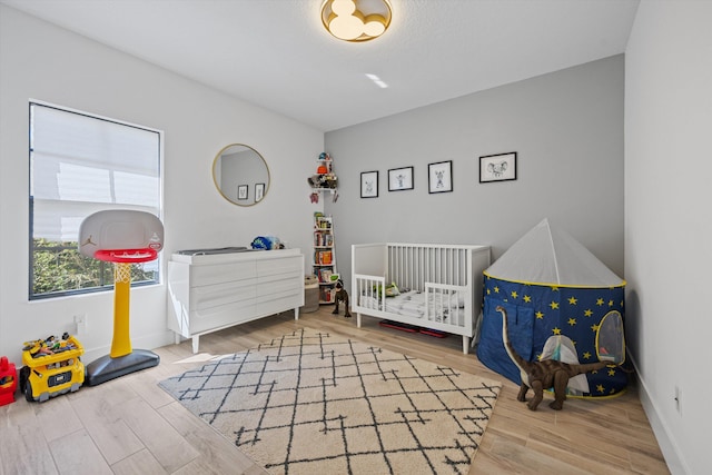 bedroom featuring baseboards and wood finished floors