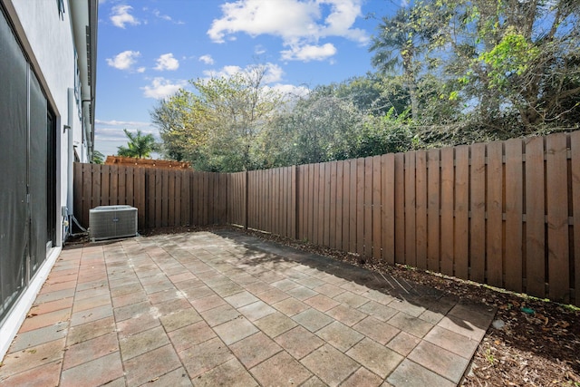 view of patio / terrace with central AC unit and a fenced backyard