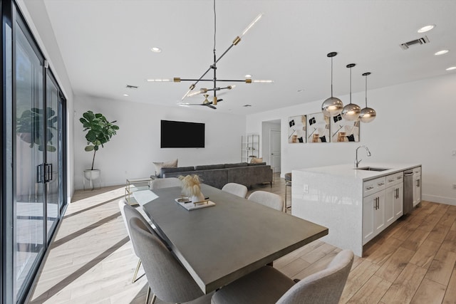 dining area featuring light wood-type flooring, visible vents, baseboards, and recessed lighting