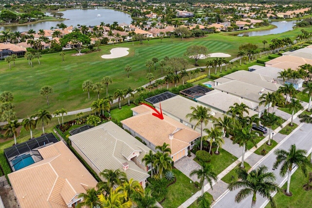 drone / aerial view with view of golf course and a residential view