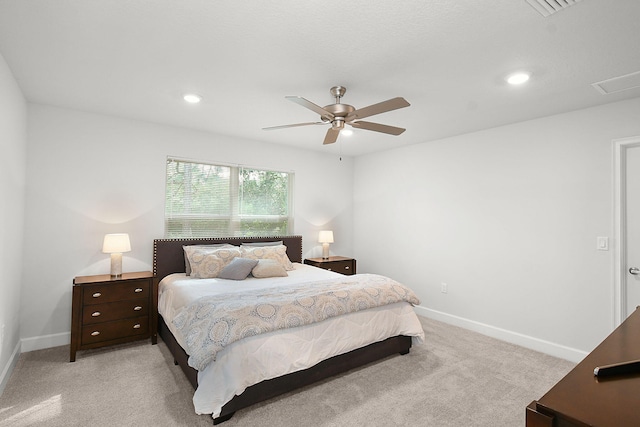 bedroom featuring recessed lighting, light colored carpet, a ceiling fan, baseboards, and attic access