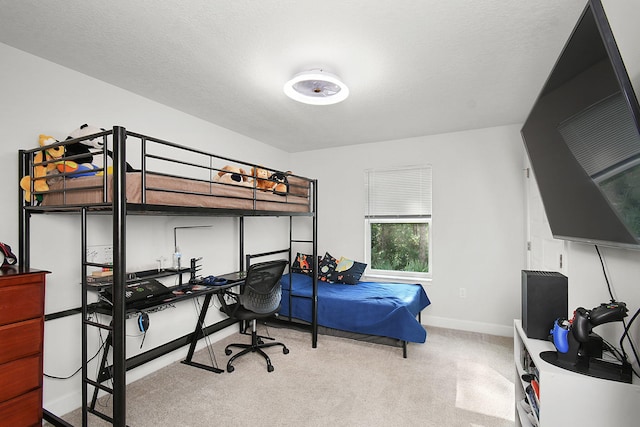 bedroom with a textured ceiling, carpet flooring, and baseboards