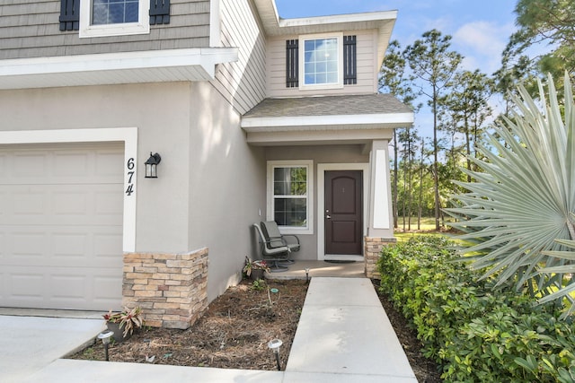 property entrance featuring stone siding, a shingled roof, and stucco siding