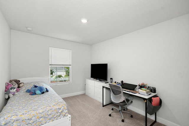 bedroom with light carpet and baseboards