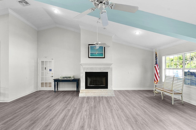 unfurnished living room with ornamental molding, wood finished floors, visible vents, and baseboards