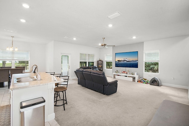 living area with recessed lighting, a healthy amount of sunlight, and light carpet