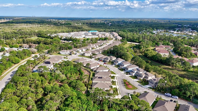 drone / aerial view with a residential view and a view of trees