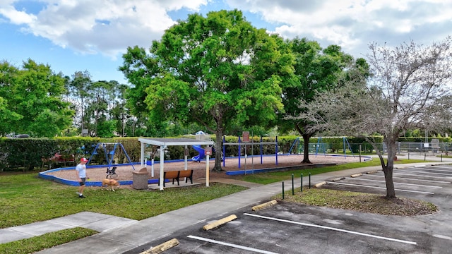 community jungle gym with fence and a lawn