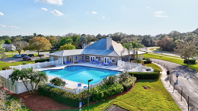 view of swimming pool with a patio area, a fenced backyard, and a lawn