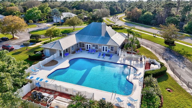 community pool featuring a patio and a fenced backyard