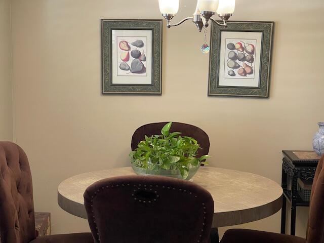 2424 N Federal Hwy Unit 106, Boynton Beach, FL 33435 - dining space with a chandelier