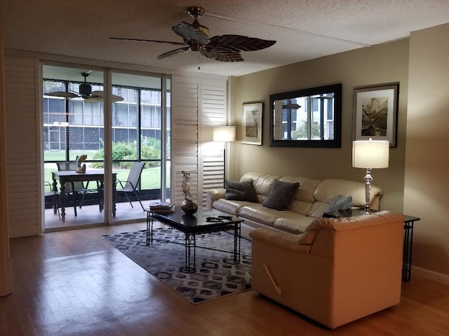 2424 N Federal Hwy Unit 106, Boynton Beach, FL 33435 - living area featuring a ceiling fan, wood finished floors, and a textured ceiling