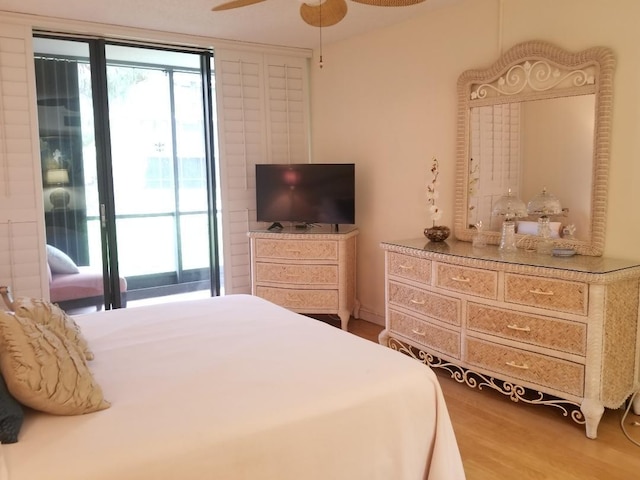 2424 N Federal Hwy Unit 106, Boynton Beach, FL 33435 - bedroom with wood finished floors, access to exterior, and multiple windows