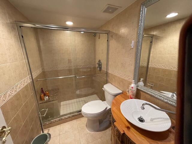 2424 N Federal Hwy Unit 106, Boynton Beach, FL 33435 - full bathroom with tile walls, visible vents, tile patterned flooring, and a shower stall