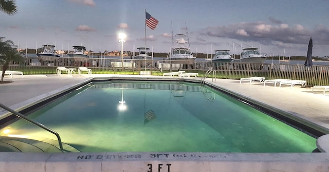 community pool featuring a patio and fence