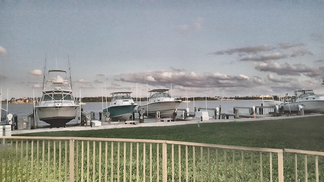 2424 N Federal Hwy Unit 106, Boynton Beach, FL 33435 - view of dock featuring a yard, a water view, and boat lift