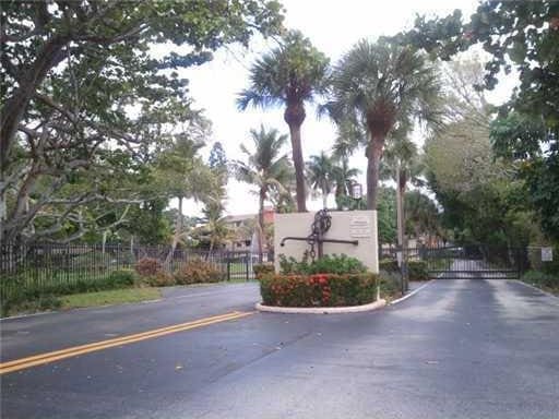 2424 N Federal Hwy Unit 106, Boynton Beach, FL 33435 - view of road featuring a gate and a gated entry