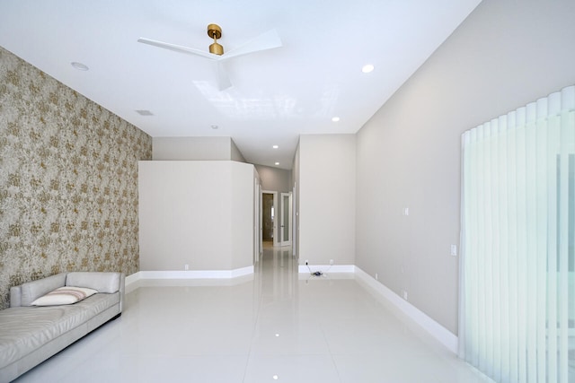 living area with wallpapered walls, baseboards, an accent wall, tile patterned flooring, and recessed lighting