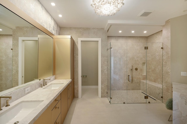 bathroom with double vanity, tile patterned flooring, a shower stall, and a sink