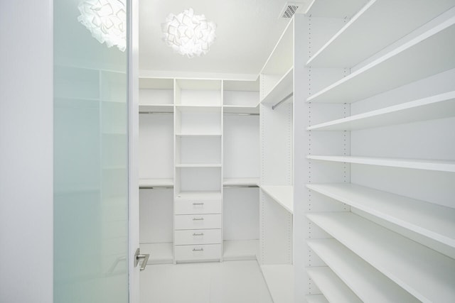 walk in closet featuring tile patterned flooring and visible vents