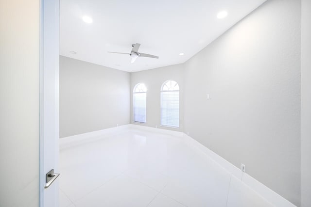 tiled empty room featuring a ceiling fan and recessed lighting