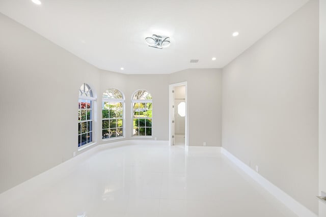 unfurnished room featuring baseboards, light tile patterned floors, visible vents, and recessed lighting