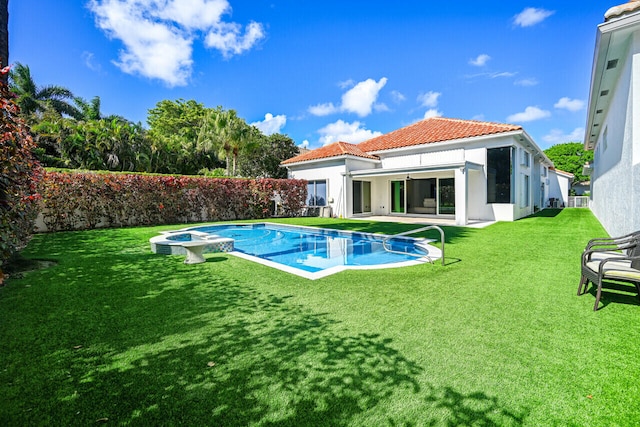 view of swimming pool featuring a pool with connected hot tub, a yard, and a patio