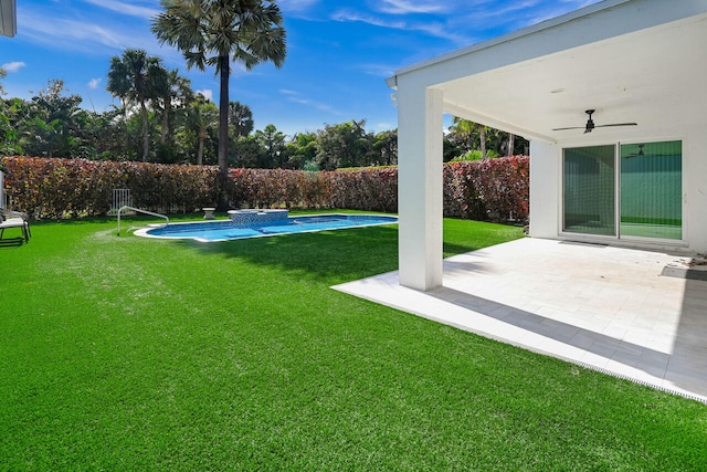 view of yard with a fenced in pool, ceiling fan, fence, and a patio