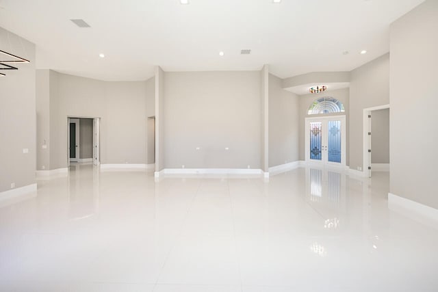 spare room featuring baseboards, french doors, light tile patterned floors, and recessed lighting