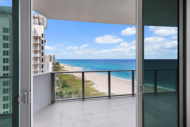 balcony with a water view and a beach view