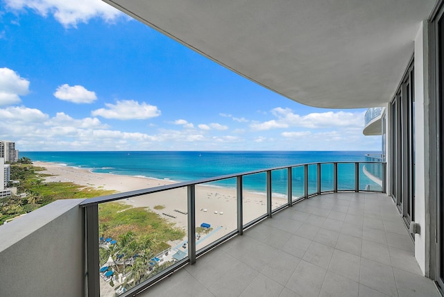 balcony with a beach view and a water view