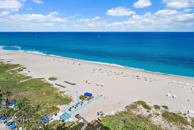 drone / aerial view featuring a view of the beach and a water view