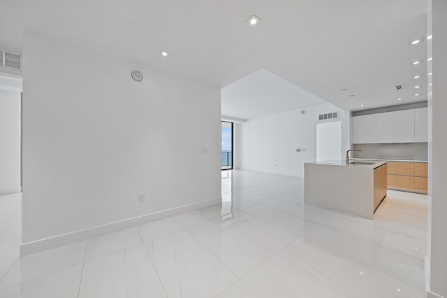 kitchen featuring white cabinetry, modern cabinets, visible vents, and open floor plan