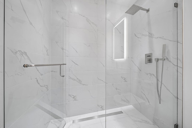 bathroom with a marble finish shower