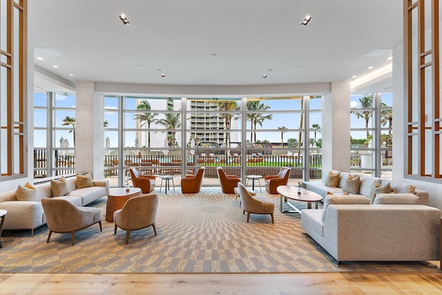 interior space with a high ceiling, wood finished floors, and recessed lighting