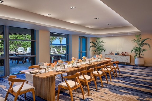 dining area with recessed lighting and a tray ceiling