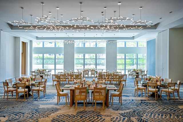 unfurnished dining area featuring a towering ceiling and a tray ceiling