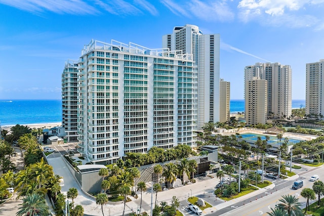 exterior space with a water view and a city view