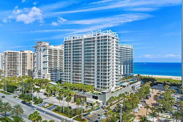 view of property featuring a water view, a beach view, and a city view