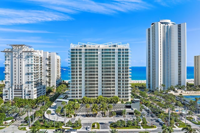 view of building exterior featuring a view of city and a water view