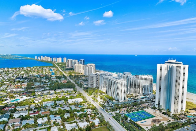 birds eye view of property with a water view and a city view