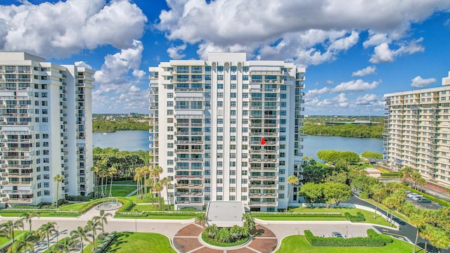 view of property with a water view and a view of city