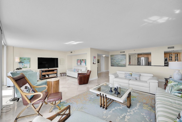 living area featuring baseboards and visible vents